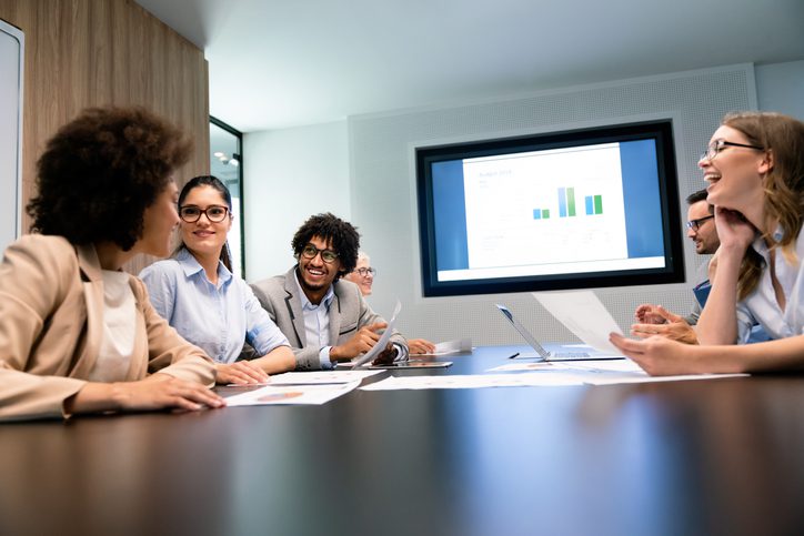 Happy business people having fun and chatting at workplace office
